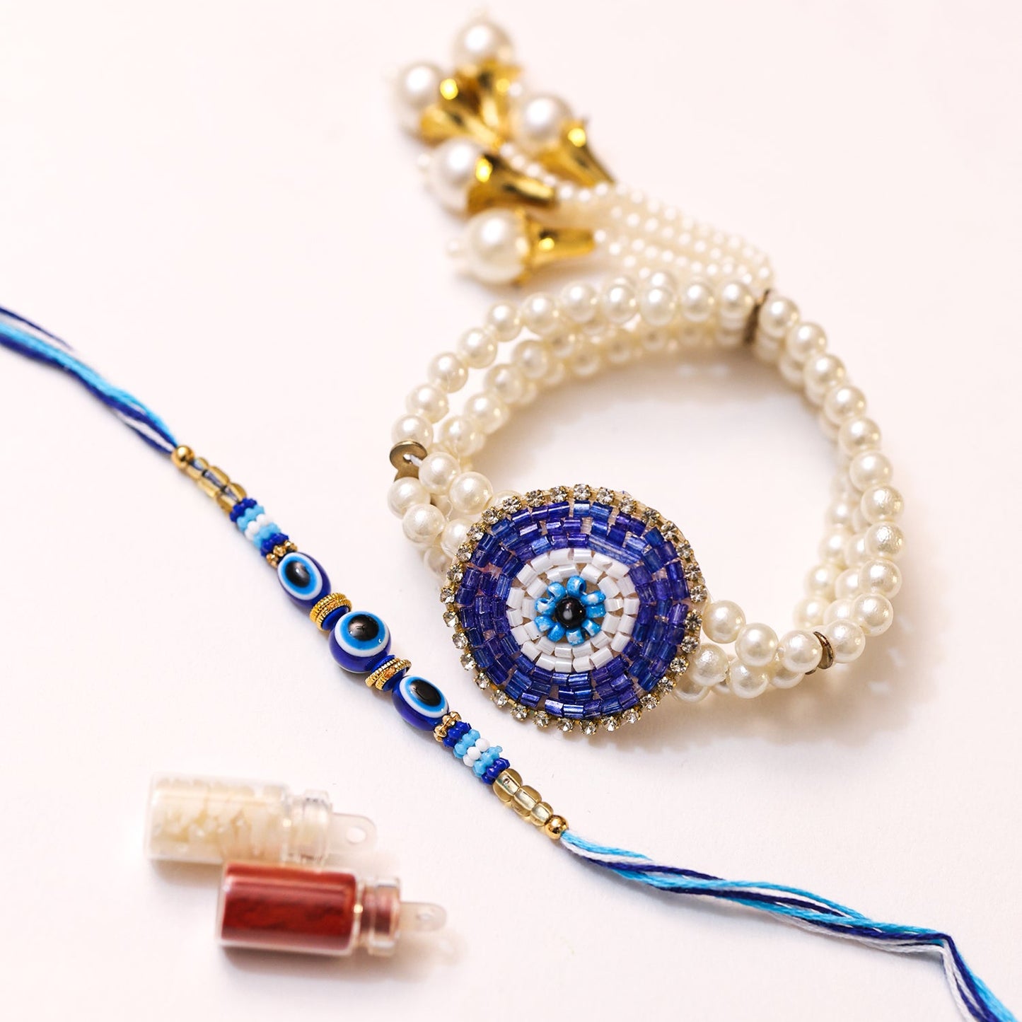 Nyraa Evil Eye Rakhi and Pearl Bracelet Combo